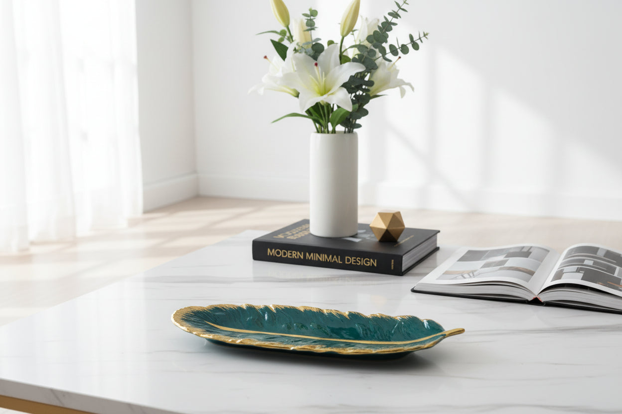 Close-up of golden rim dark green feather tray