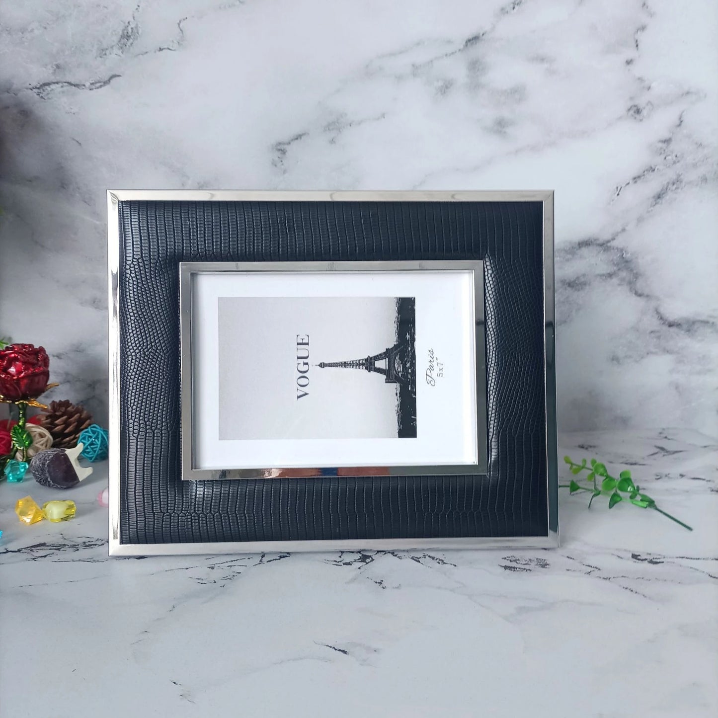 Decorative black leather frame on console with photo