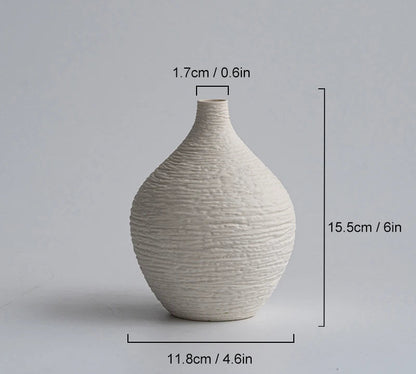 Small off-white ceramic vase with dimensions on a gray background