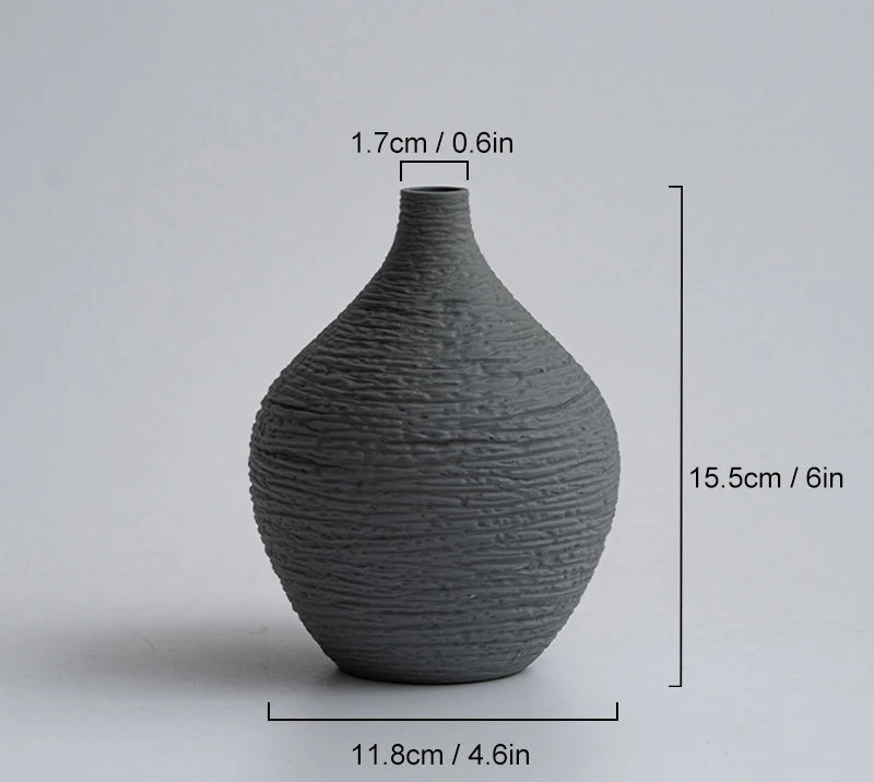 Dark grey textured vase with measurements on a light gray background