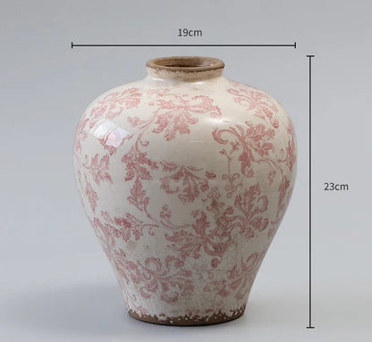 Ceramic vase with red floral patterns and measurements on a gray background