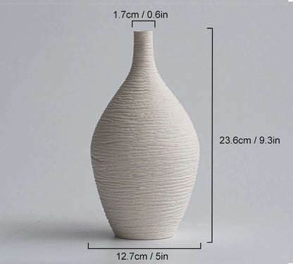Off-white ceramic vase with dimensions on a gray background