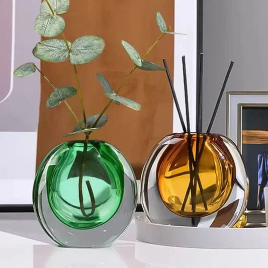 Mini glass vases styled with small flowers on shelf