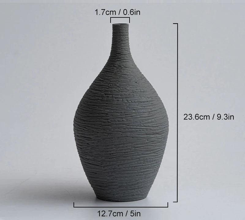 Dark grey vase with measurements on a light gray background