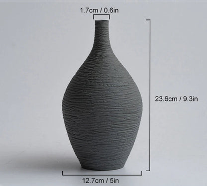 Dark grey vase with measurements on a light gray background